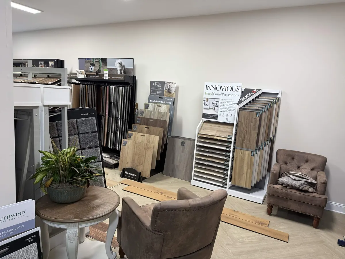 Seating area beside flooring sample racks in the Hometown Floor Covering showroom
